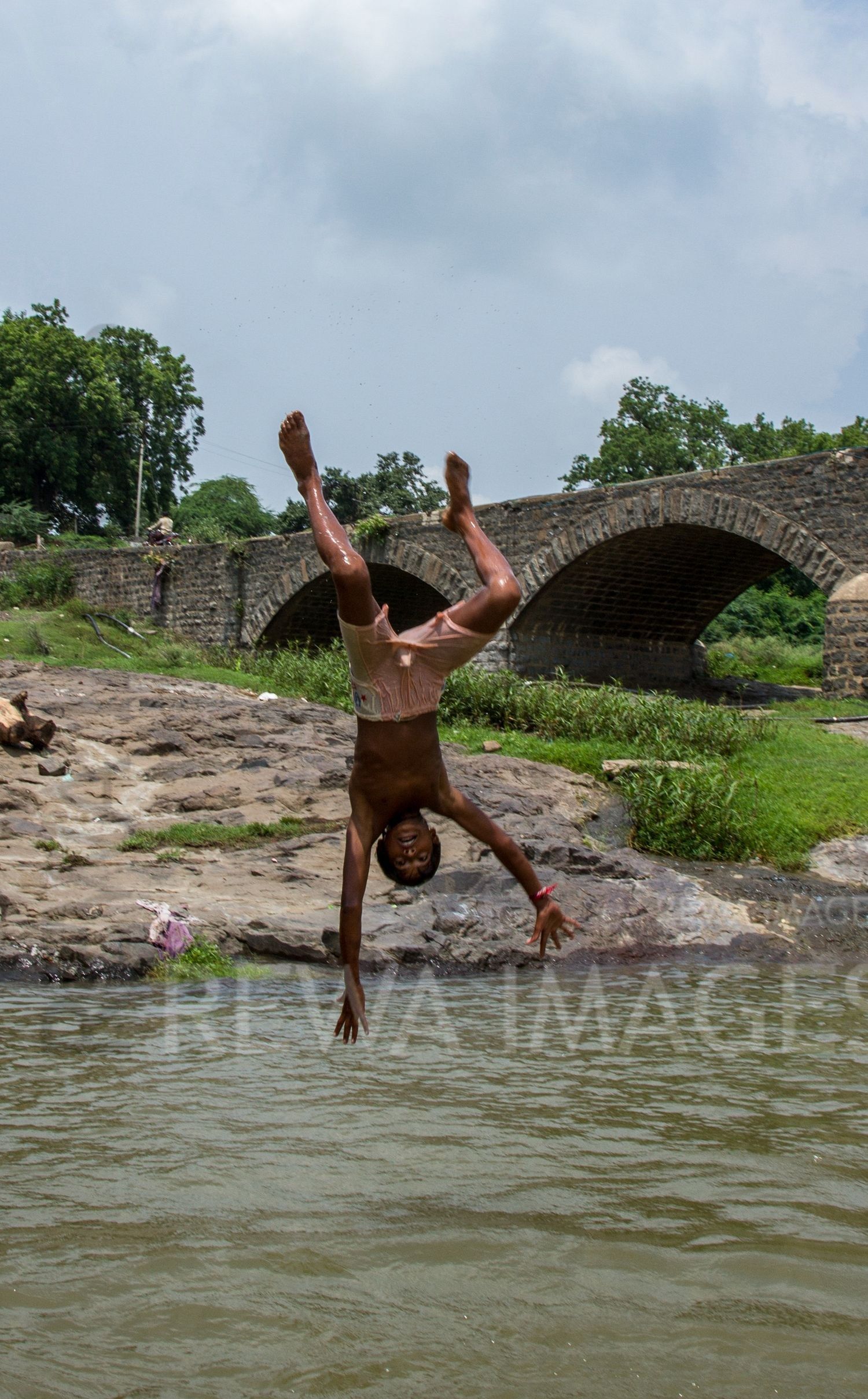 Kids leaping into the river