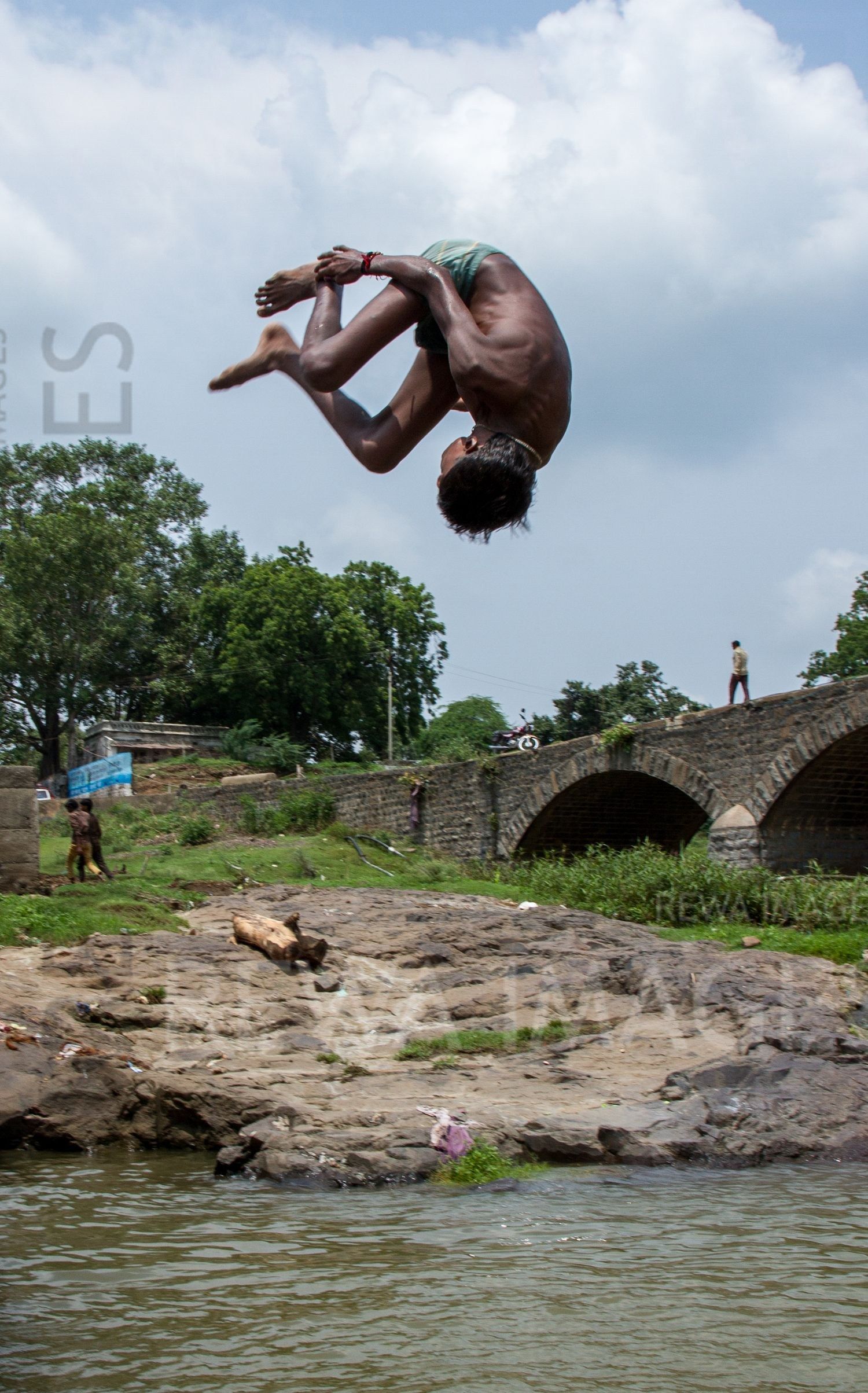 Kids leaping into the river
