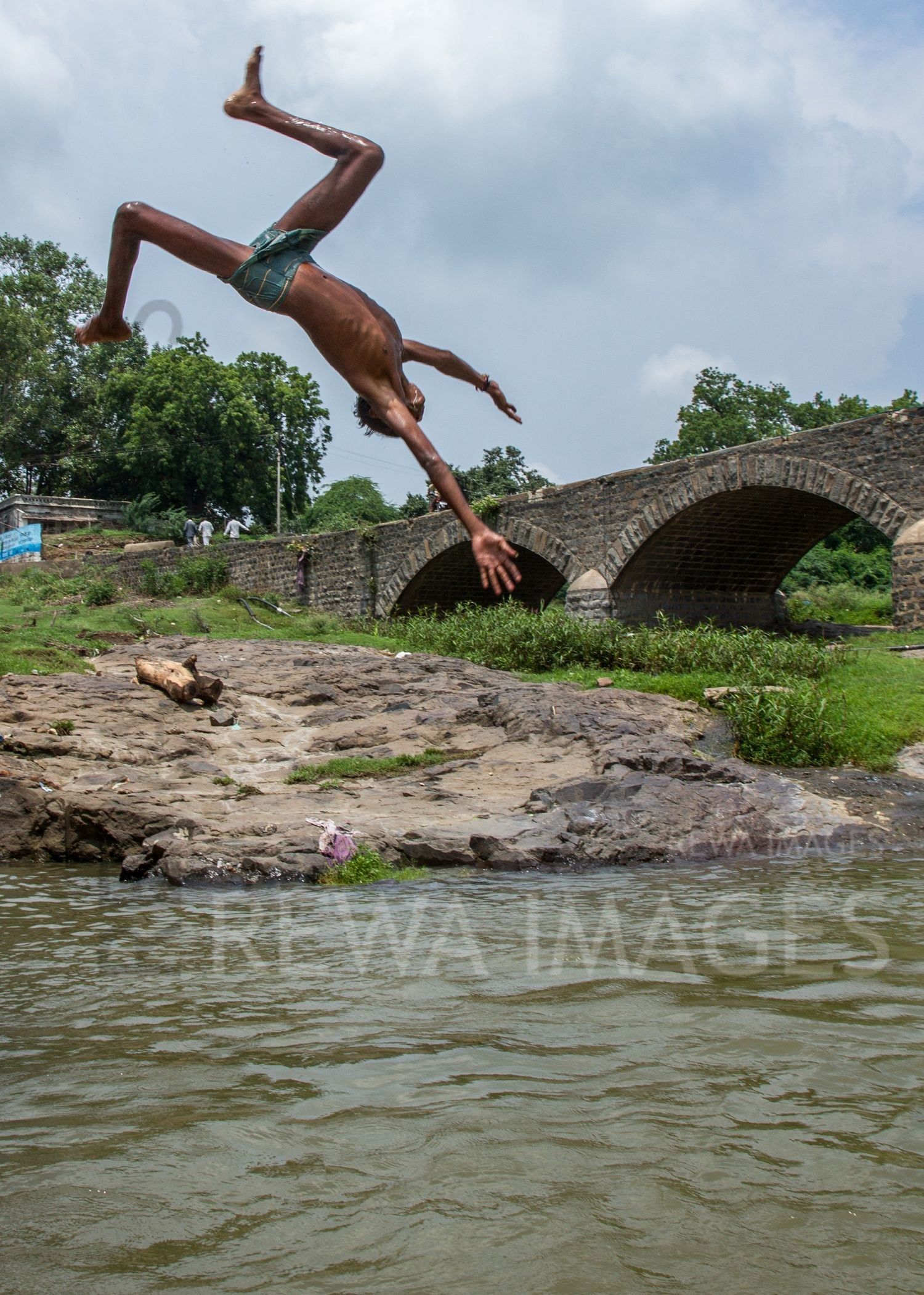 Kids leaping into the river