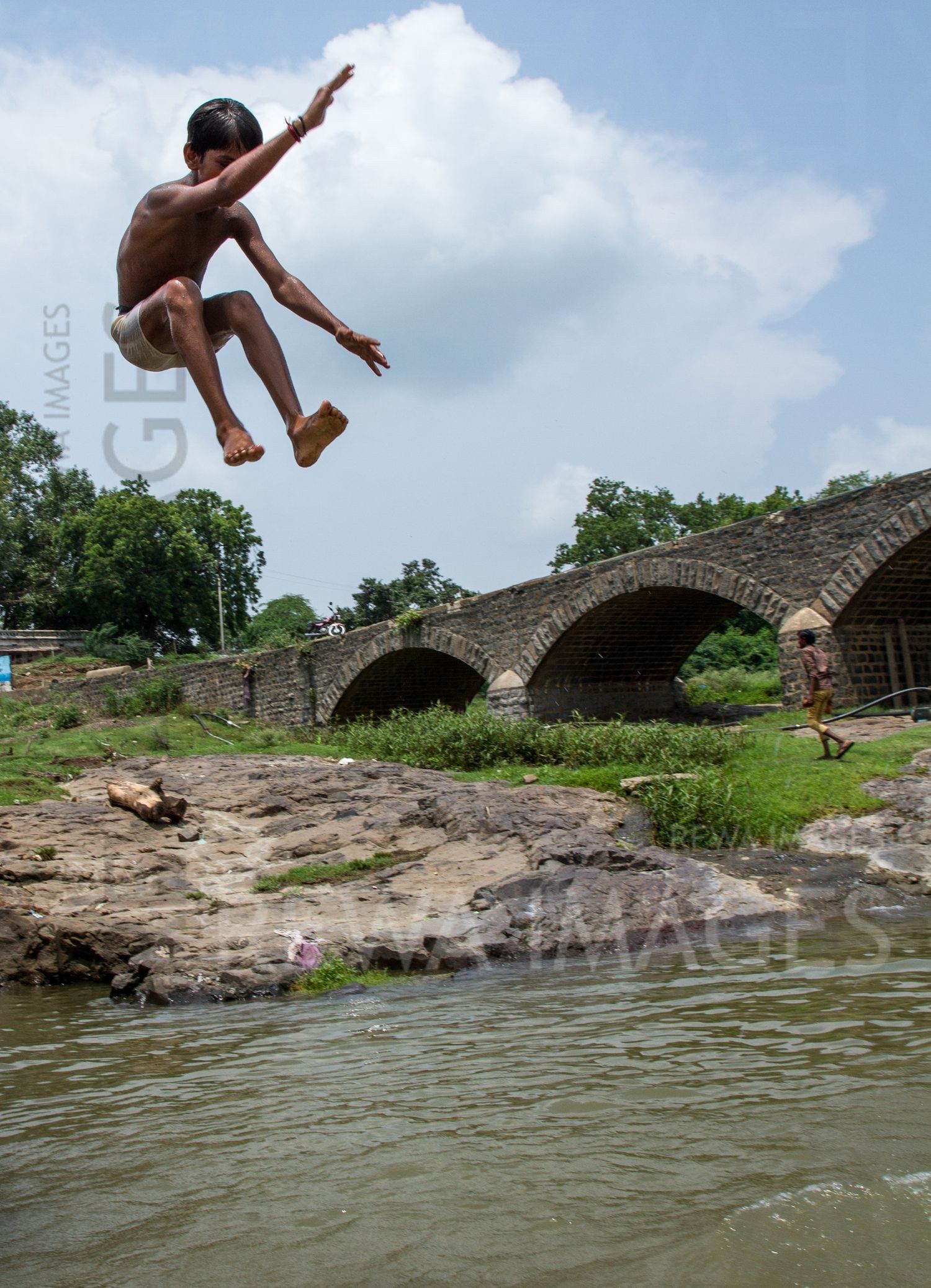 Kids leaping into the river