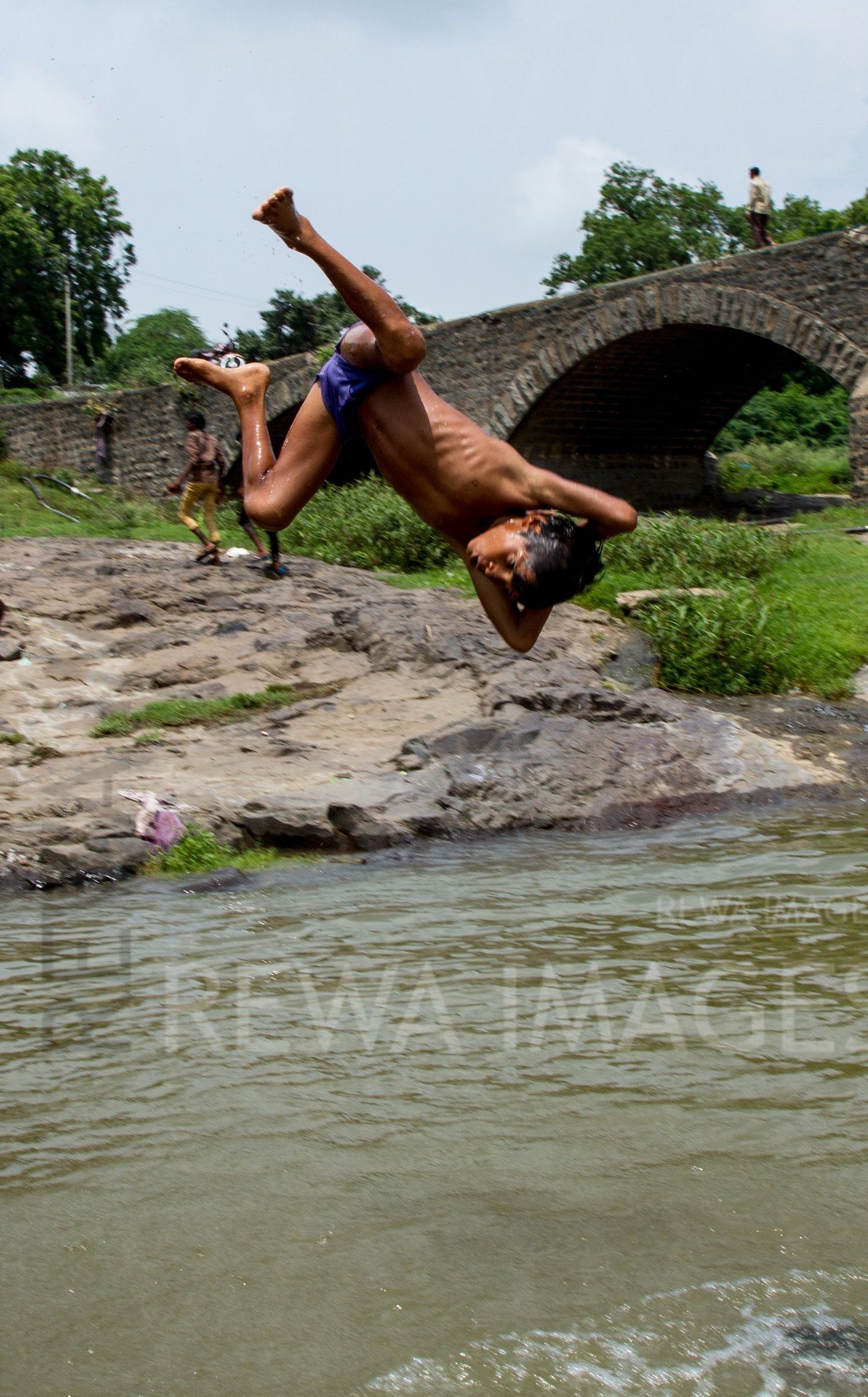 Kids leaping into the river