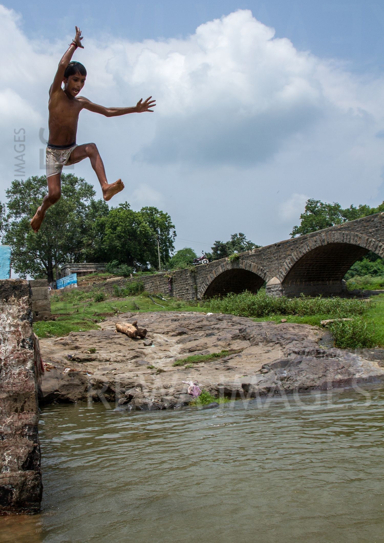 Kids leaping into the river