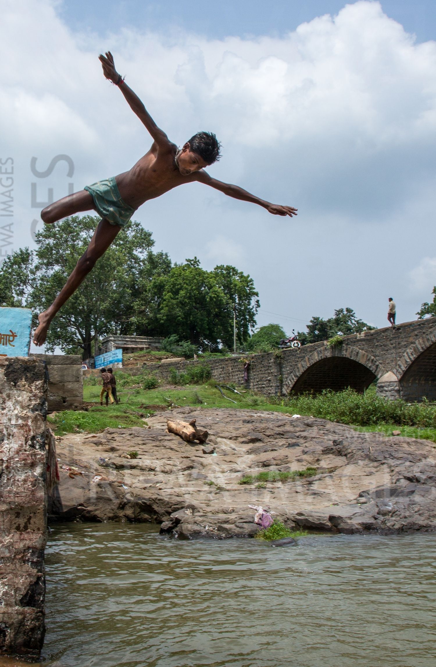 Kids leaping into the river