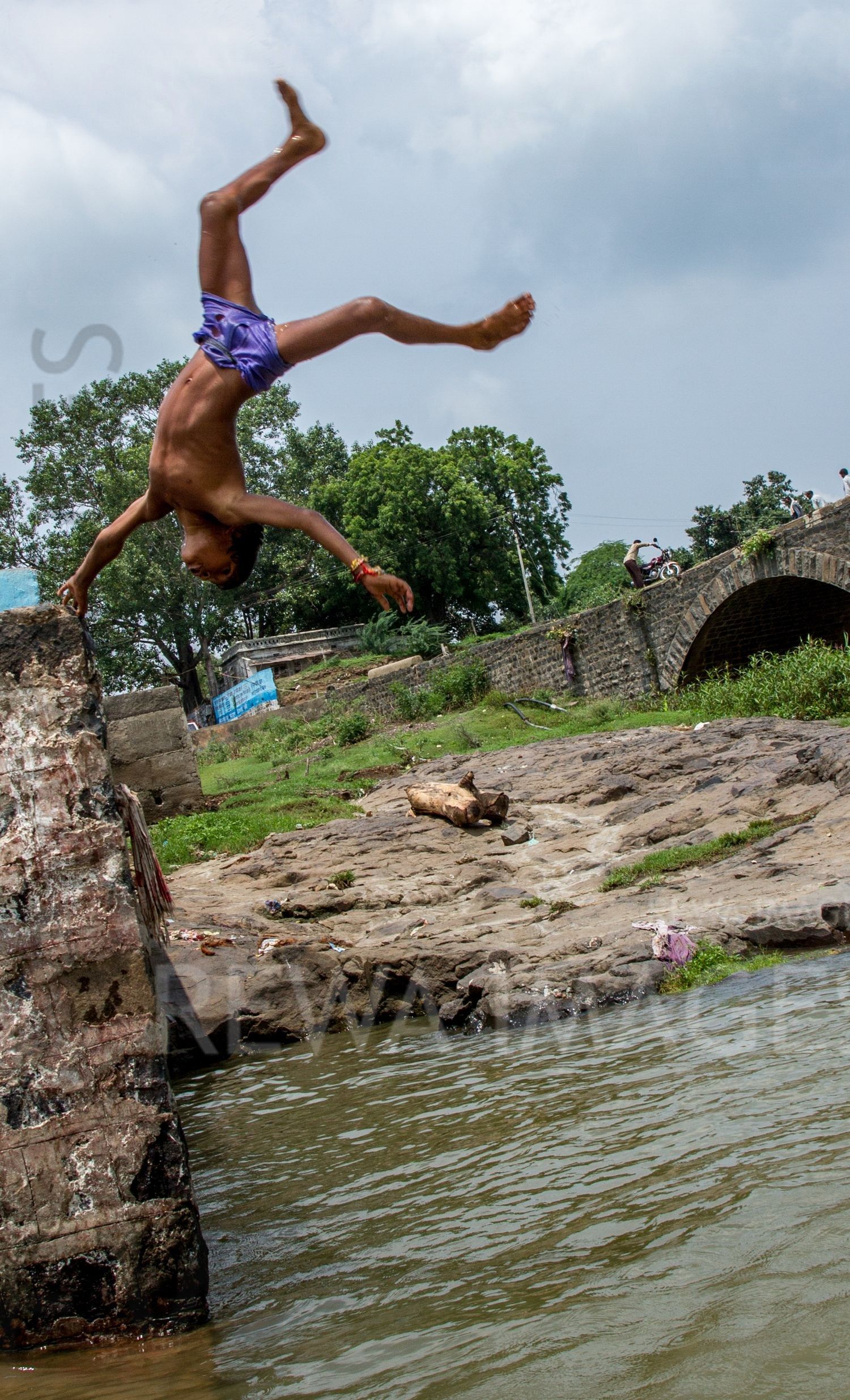 Kids leaping into the river