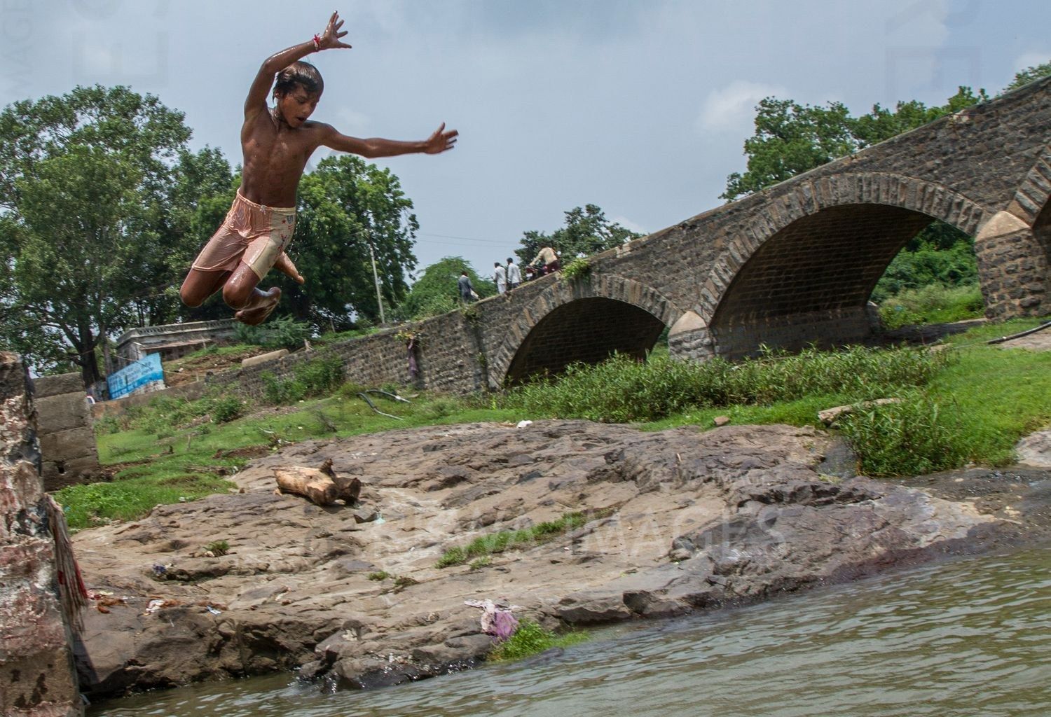 Kids leaping into the river