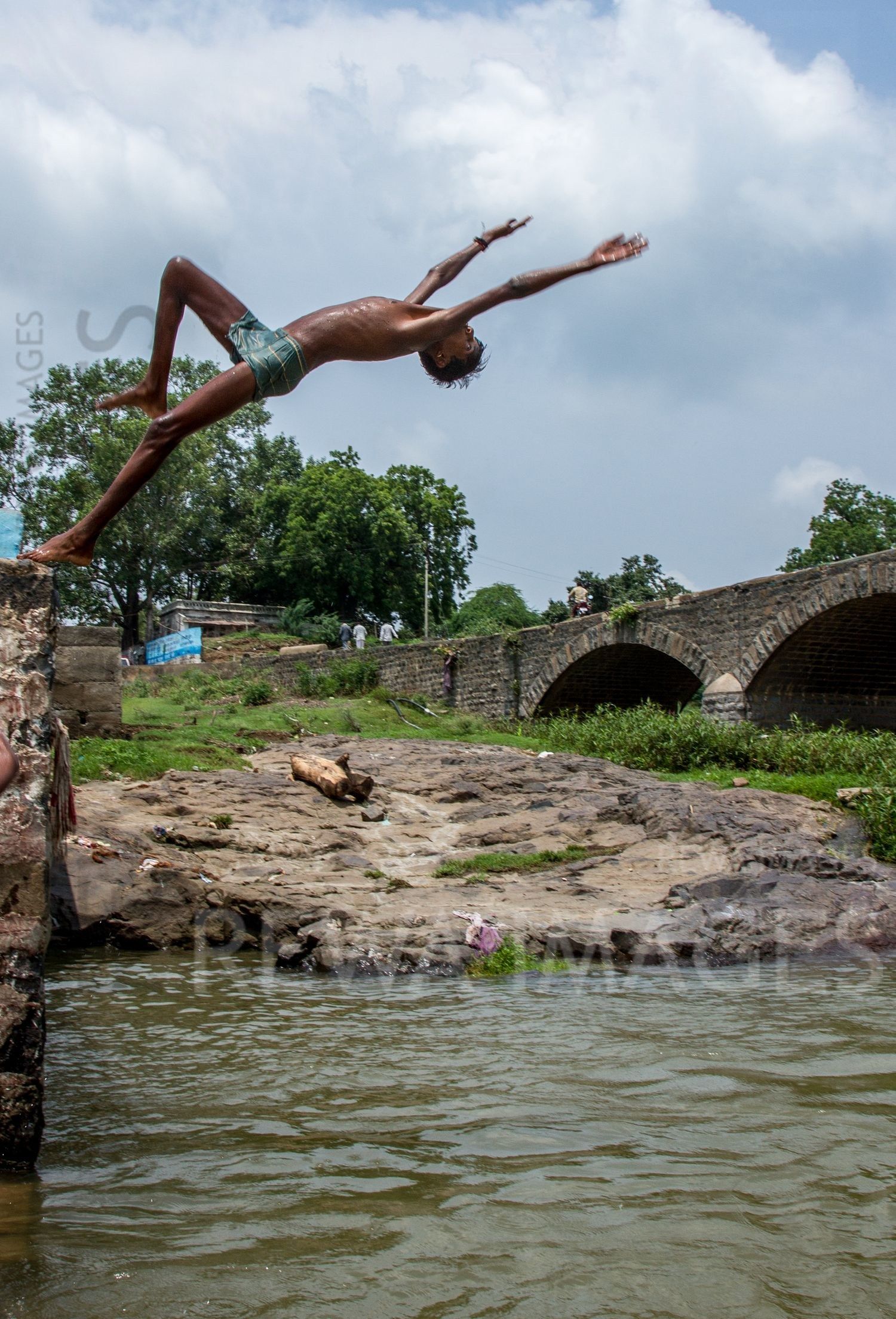 Kids leaping into the river