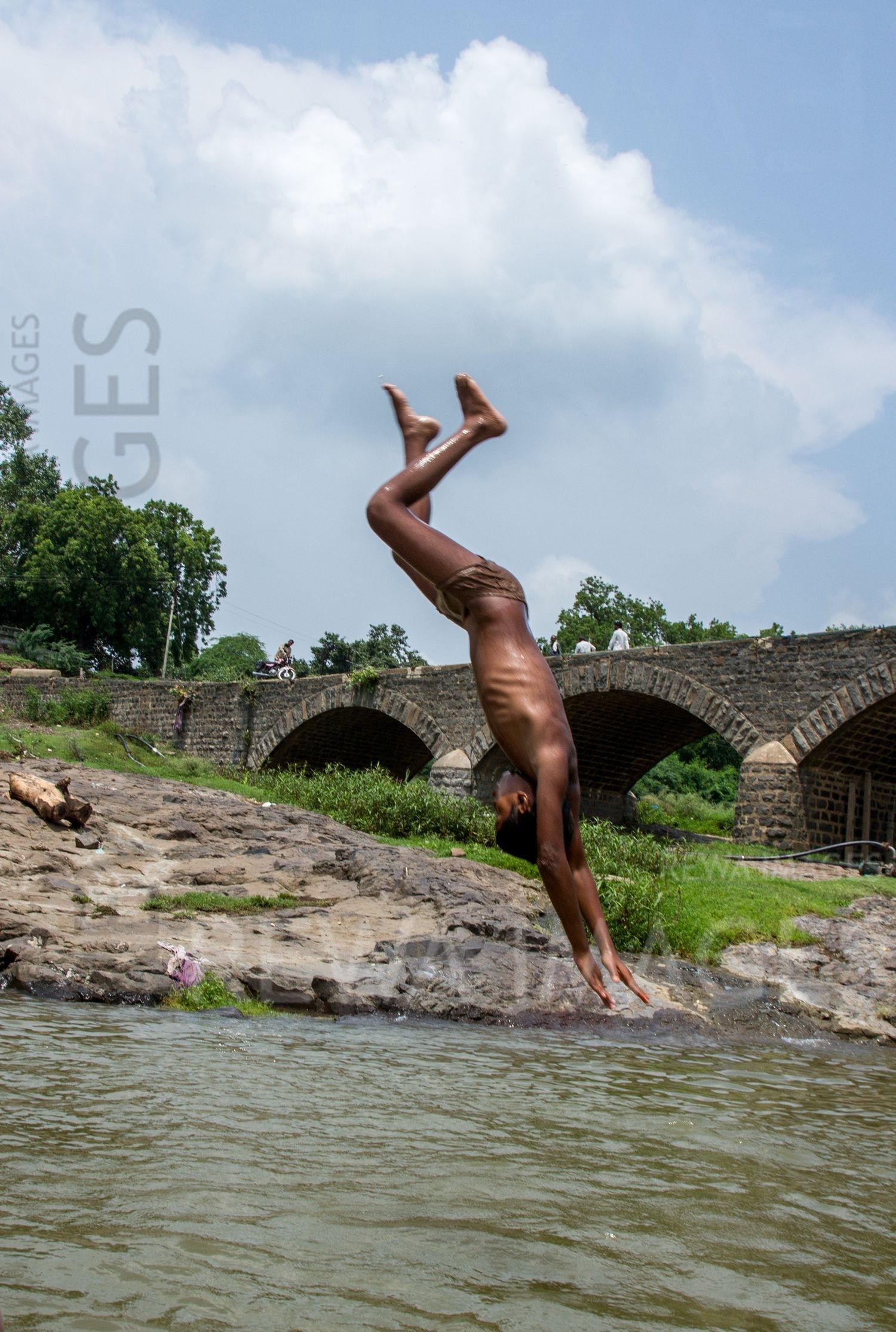 Kids leaping into the river