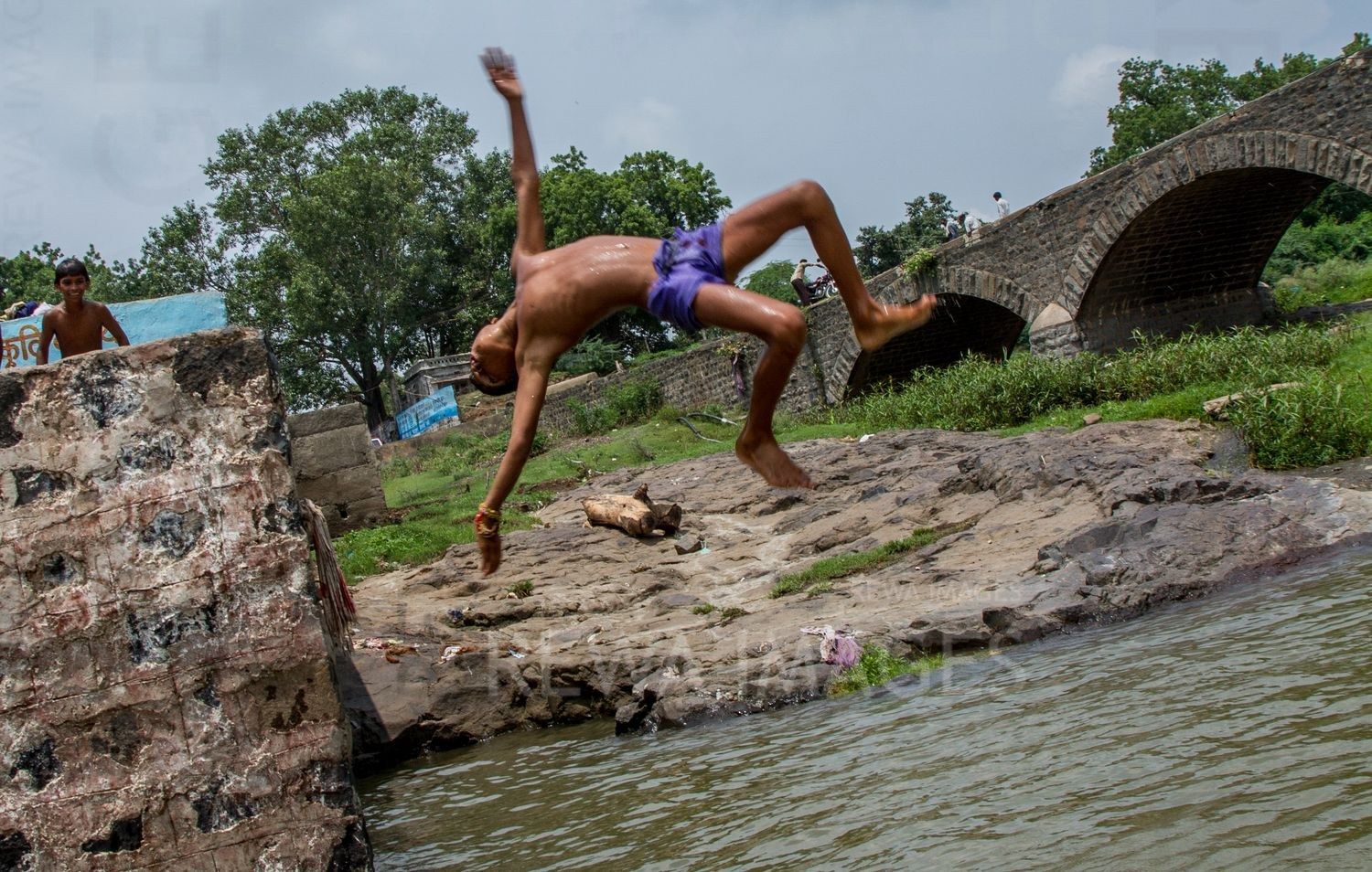 Kids leaping into the river