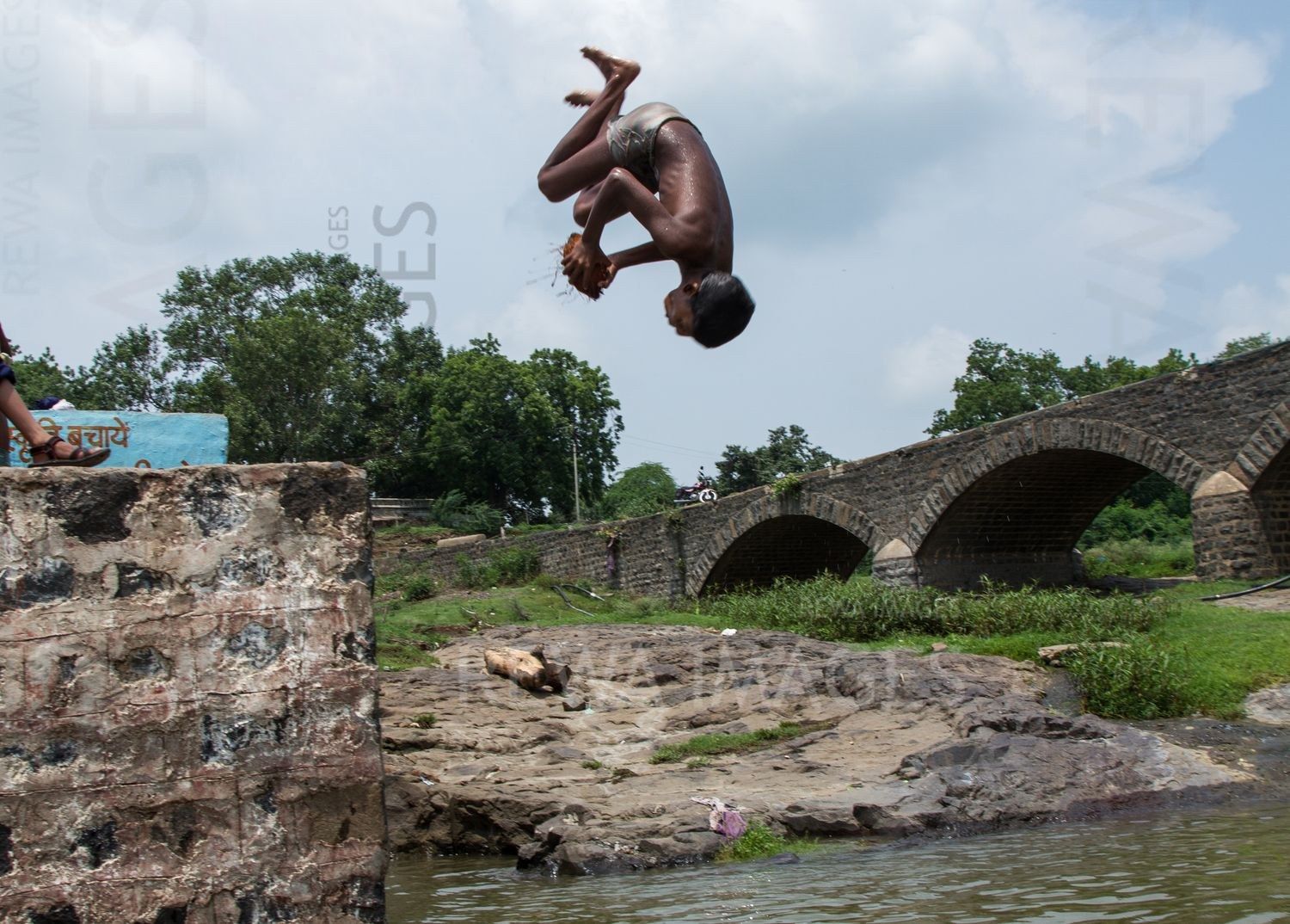Kids leaping into the river