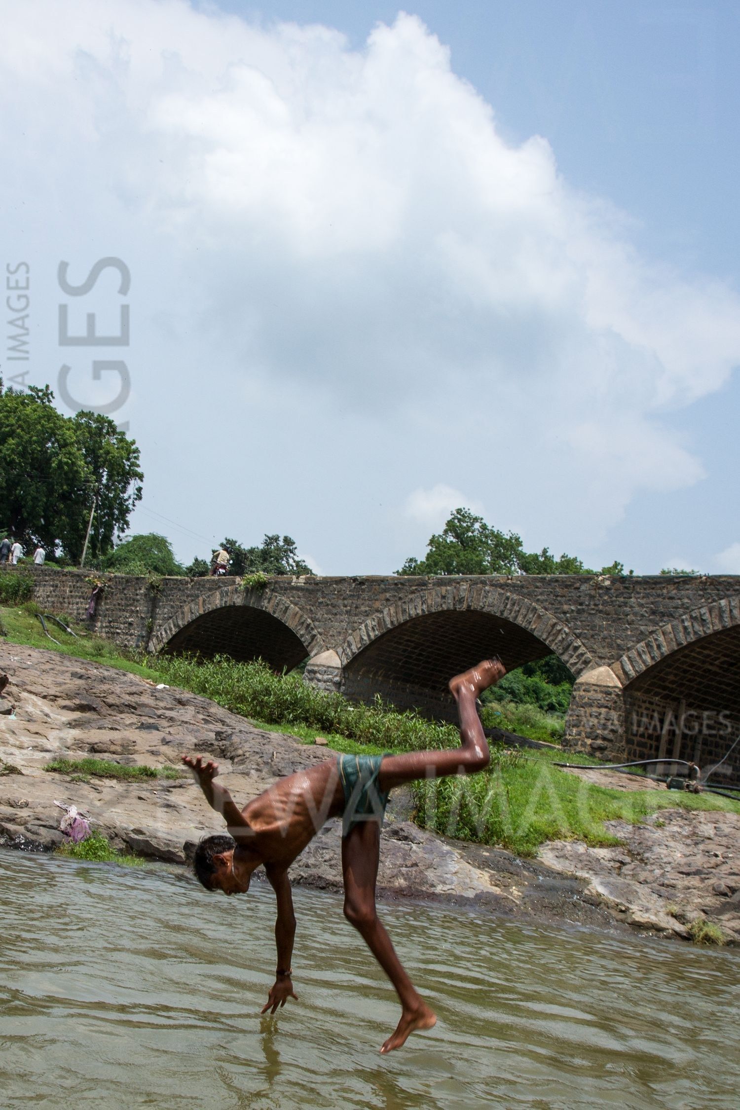 Kids leaping into the river