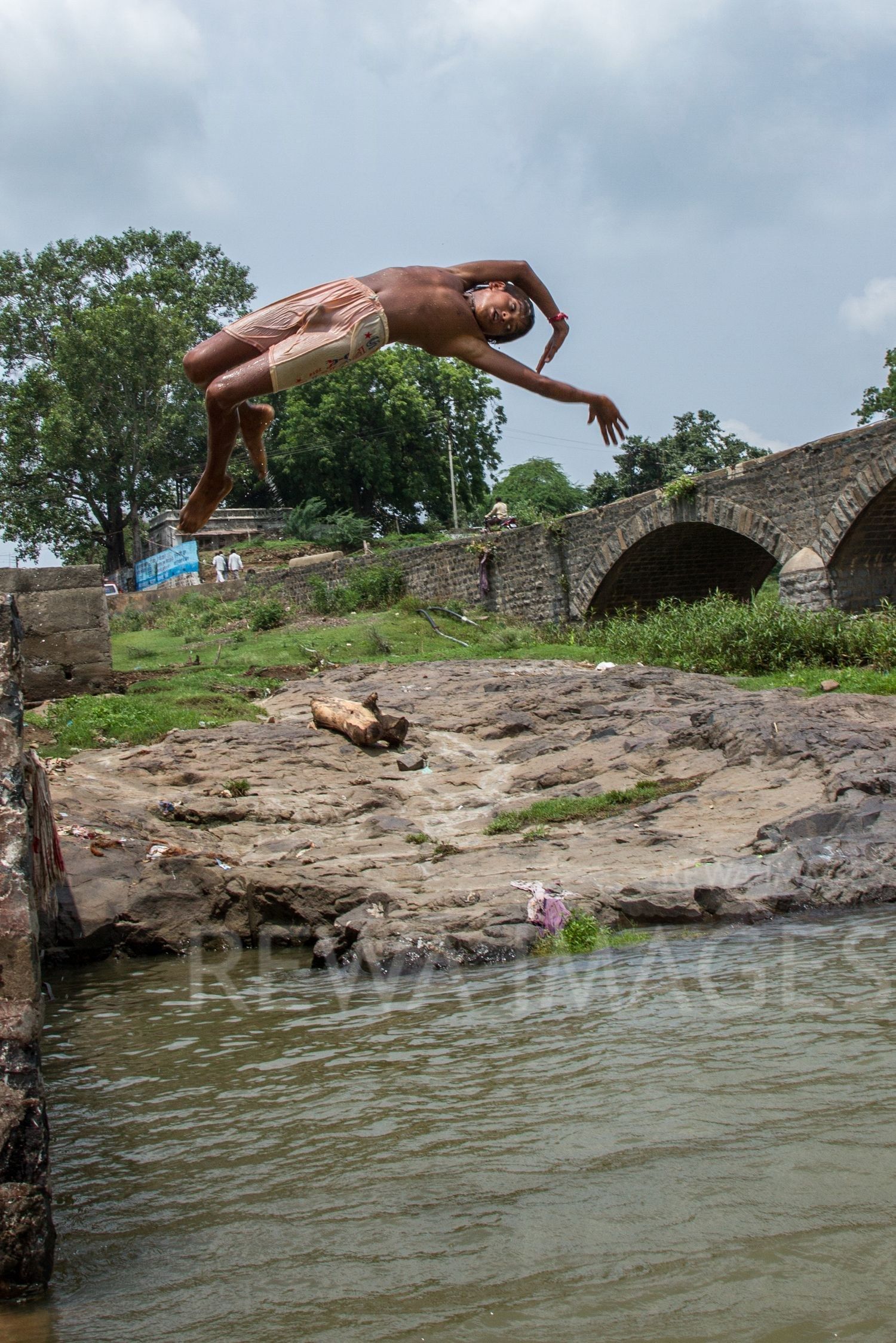 Kids leaping into the river