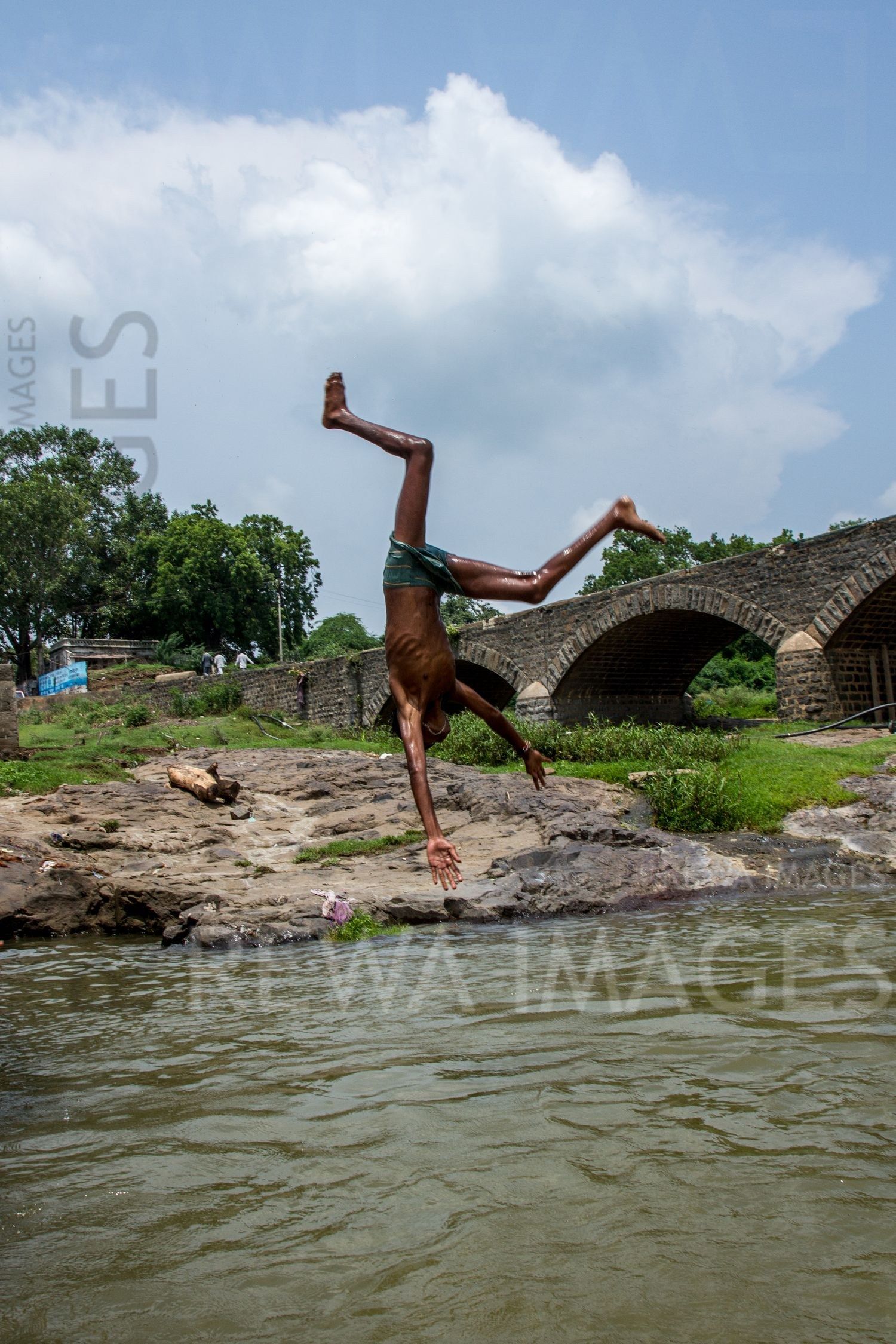 Kids leaping into the river